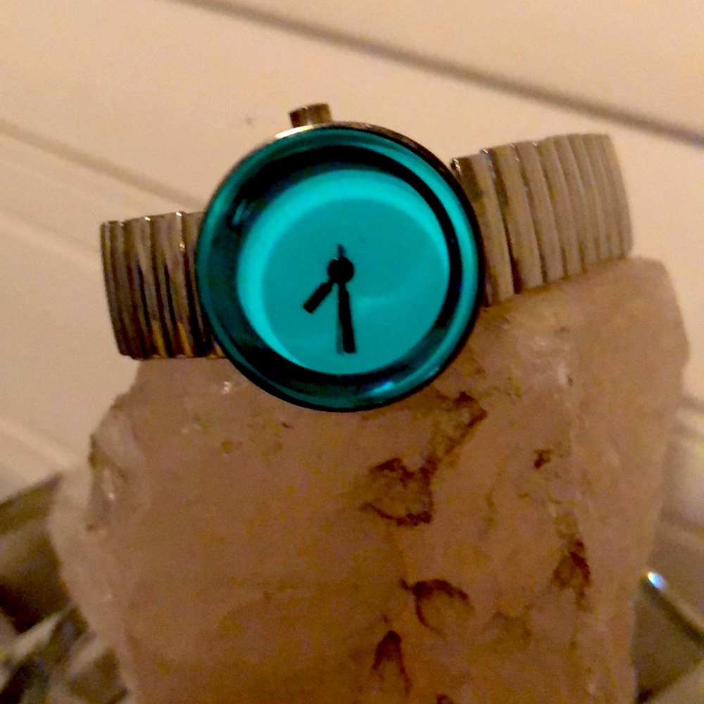 Ladies stretch watch with raised turquoise glass.
